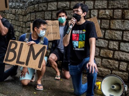 Protesters hold Black Lives Matter signs outside the US consulate during a demonstration against racism and police brutality in Hong Kong on June 7, 2020, following the death of George Floyd on May 25, 2020, while being arrested in Minneapolis, Minnesota.