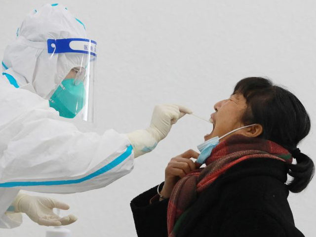 A resident undergoes a nucleic acid test for the Covid-19 coronavirus in Hangzhou in China