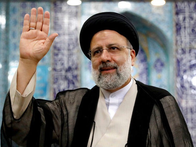 Ebrahim Raisi, a candidate in Iran's presidential elections (now president) waves to the media after casting his vote at a polling station in Tehran, Iran Friday, June 18, 2021. Iran began voting Friday in a presidential election tipped in the favor of a hard-line protege of Supreme Leader Ayatollah Ali …