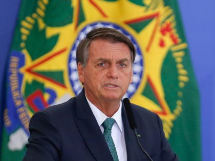 Brazilian President Jair Bolsonaro gestures during the launching of a national program to provide voluntary civil service at the Planalto Palace in Brasilia, on January 28, 2022. (Photo by Sergio Lima / AFP) (Photo by SERGIO LIMA/AFP via Getty Images)