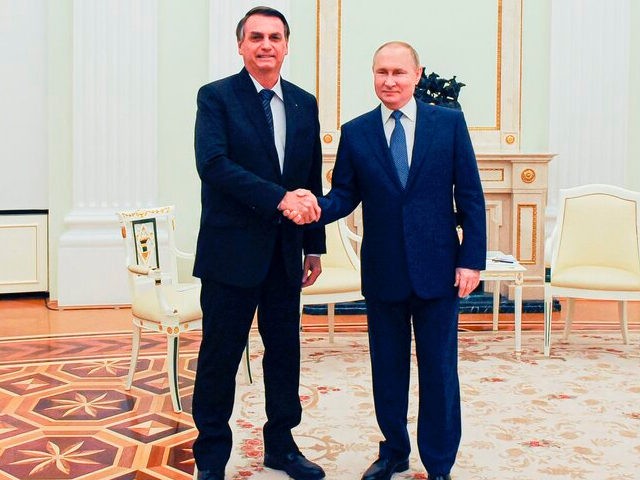 Russian President Vladimir Putin, right, and Brazil's President Jair Bolsonaro pose for a