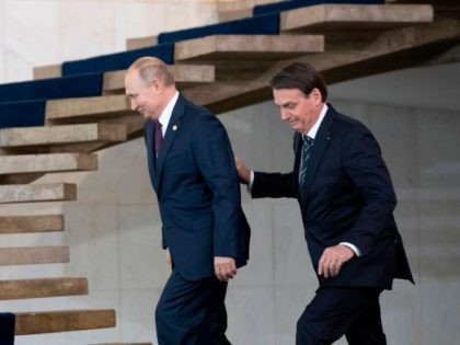 Russia's President Vladimir Putin (L) and Brazil's President Jair Bolsonaro walk