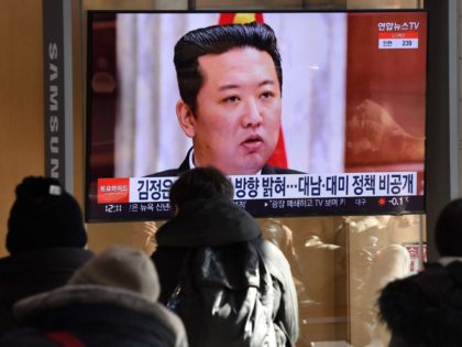People watch a television news programme showing a picture of North Korean leader Kim Jong Un attending a plenary meeting of the Central Committee of the Workers' Party of Korea, at a railway station in Seoul on January 1, 2022. (Photo by Jung Yeon-je / AFP) (Photo by JUNG YEON-JE/AFP …