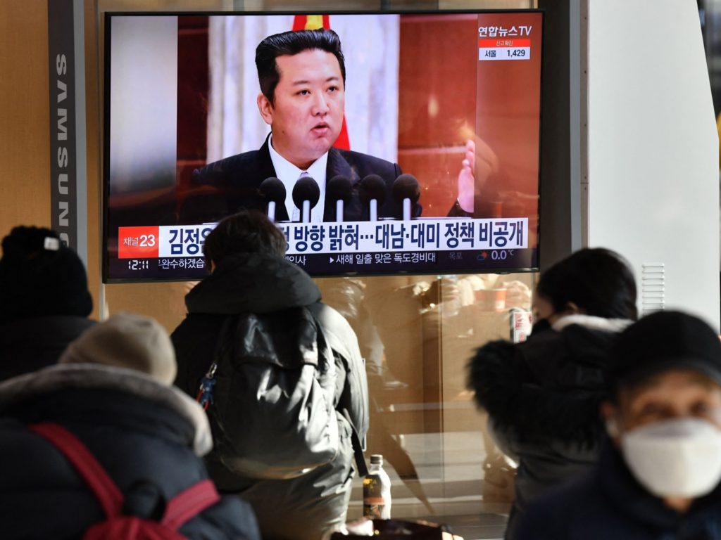 People watch a television news programme showing a picture of North Korean leader Kim Jong Un attending a plenary meeting of the Central Committee of the Workers' Party of Korea, at a railway station in Seoul on January 1, 2022. (Photo by Jung Yeon-je / AFP) (Photo by JUNG YEON-JE/AFP via Getty Images)