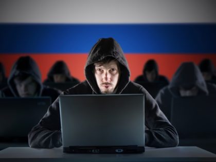 Many russian hackers in troll farm. Cyber crime and security concept. Russia flag in backg