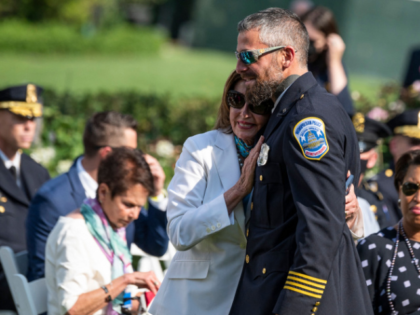 Speaker of the House Nancy Pelosi hugs Capitol Police Officer Michael Fanone during an event where US President Joe Biden signed H.R. 3325, "An Act to award four congressional gold medals to the United States Capitol Police and those who protected the U.S. Capitol on January 6, 2021," into law …