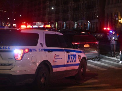 Police officers lock down the scene after two NYPD officers were shot in Harlem on January