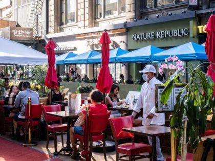 NEW YORK, NY - JULY 21: People dine al fresco, or open air, in Koreatown on July 21, 2020, in New York City. New York City's Open Restaurant Program, which seeks to phase in city-side options to expand outdoor seating for food establishments, has been extended through October.