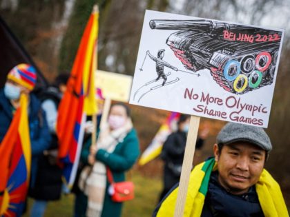 A protester holds a placard during a protest march gathering Tibetans from the International Olympic Committee (IOC) headquarters to the Olympic Museum ahead of the opening of the Beijing 2022 Winter Olympics, in Lausanne on February 3, 2022.