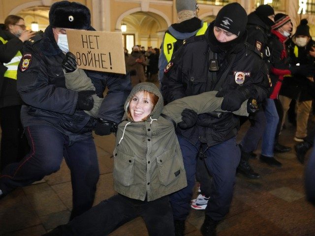 Police officers detain a demonstrator holding a sign reading 'No war!' during an action against Russia's attack on Ukraine in St. Petersburg, Russia, Thursday, Feb. 24, 2022. Hundreds of people gathered in the center of Moscow on Thursday, protesting against Russia's attack on Ukraine. Many of the demonstrators were detained. …
