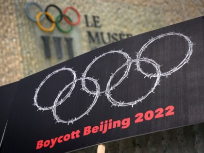 This photograph taken on June 23, 2021 shows a placard representing barbed wire shaping Olympics Rings seen next to a sign of the Olympics Museum during a protest organised by Tibetan and Uyghur activists against Beijing 2022 Winter Olympics in Lausanne as some 200 participants took part to the protest.