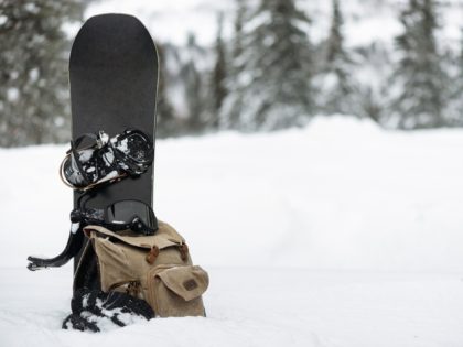 Stock photo of snowboard in the snow (iStock/Getty Images Plus)