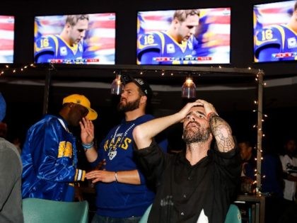Fans react during a viewing party for the Super Bowl 53 football game between the New England Patriots and the Los Angeles Rams in Los Angeles, Sunday, Feb. 3, 2019. (AP Photo/Ringo H.W. Chiu)
