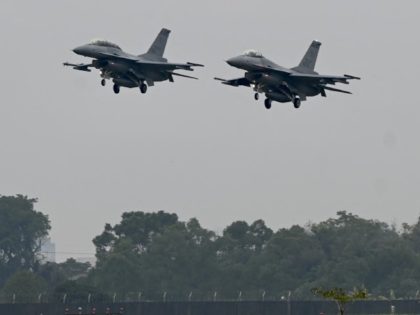 Two armed US-made F-16V fighters fly over an air force base in Chiayi, southern Taiwan on