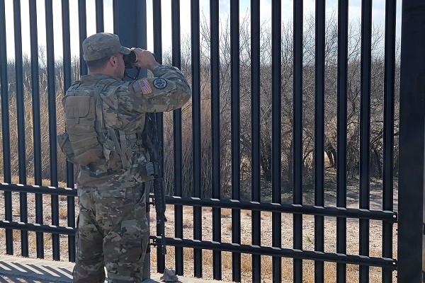 A Texas National Guard soldier stands watch along the Rio Grande in Del Rio under Operation Lone Star. (Bob Price/Breitbart Texas)