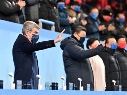 International Olympic Committee (IOC) President Thomas Bach (C)and Chinese President Xi Jinping (R) wave during the Opening Ceremony of the Beijing 2022 Winter Olympics at the Beijing National Stadium on February 04, 2022 in Beijing, China. Photo by Anthony Wallace - Pool/Getty Images