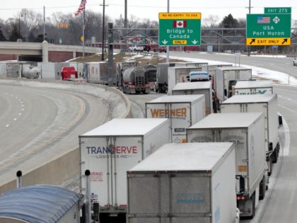 Trucks lined up at the Blue Water Bridge that connects Port Huron, Michigan, and Sarnia, Canada, in Port Huron on February 10, 2022. - The Canadian trucker protest has temporarily sidelined a key auto industry transport route, adding stress to a North American car industry already pinched by low inventories …