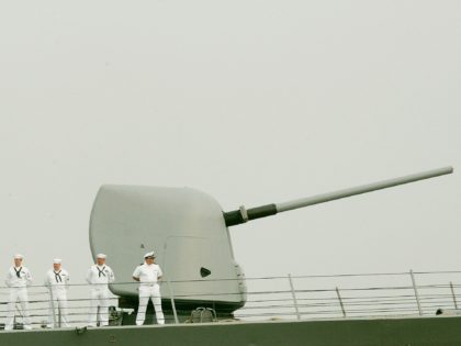 NORFOLK, VA - JUNE 08: U.S. Navy Sailors stand on the deck of the USS Cole as she departs the Norfolk Naval Station June 8, 2006 in Norfolk, Virginia. The Cole is departing for the Middle East for the first time since it was bombed by terrorists during a refueling …
