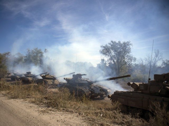 A column of Pro-Russian rebel tanks prepare to move from the front line near Oleksandrivka
