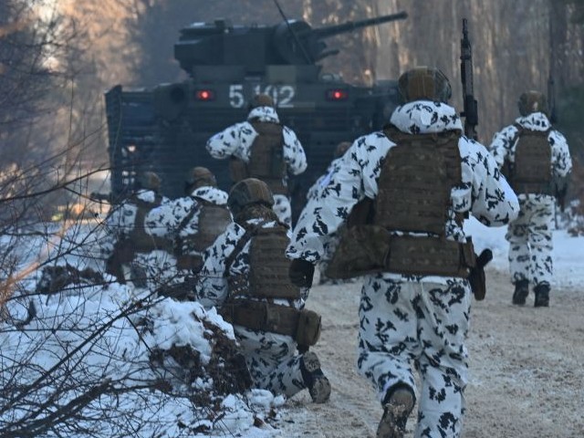 Servicemen take part in a joint tactical and special exercises of the Ukrainian Ministry of Internal Affairs, the Ukrainian National Guard and Ministry Emergency in a ghost city of Pripyat, near Chernobyl Nuclear Power Plant on February 4, 2022. (Photo by Sergei Supinsky/AFP via Getty Images)