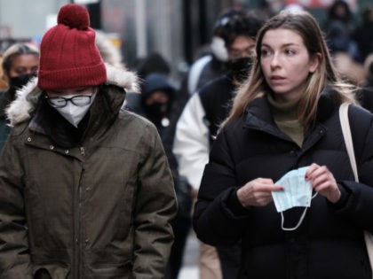 People wear face masks in Manhattan on November 29, 2021 in New York City. Across New York City and the nation, people are being encouraged to get either the booster shot or the Covid-19 vaccine. (Photo by Spencer Platt/Getty Images)