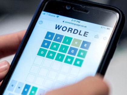 This photo illustration shows a person playing online word game "Wordle" on a mobile phone in Washington, DC on January 11, 2022. (Photo by Stefani Reynolds/AFP via Getty Images)