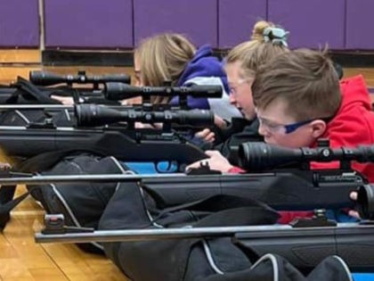 Fifth graders in Wyoming's Hot Springs County School District #1 took marksmanship courses in early February using air rifles in a make-shift gun range in their school gym. (Screengrab/Facebook/Deer Blinds and Fishing Lines Facebook Page)