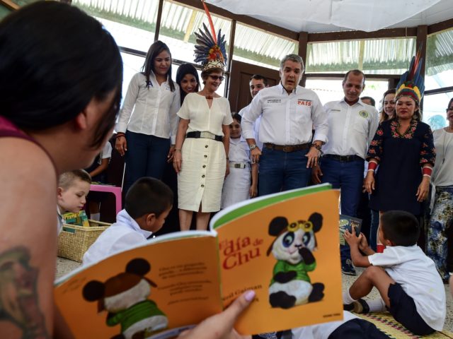 Colombian President Ivan Duque talks with children at a school in Leticia, department of A