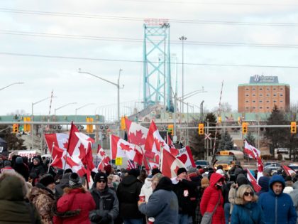 Protestors against Covid-19 vaccine mandates block the entrance to the Ambassador Bridge in Windsor, Ontario, Canada, on February 12, 2022. - Police in Canada were positioning Saturday to clear the bridge on the US border, snarled for days by truckers protesting against vaccination rules, an AFP journalist observed. "We urge …