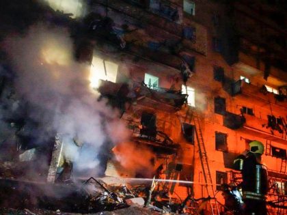 In this handout photo taken from video released by Ukrainian Police Department Press Service released on Friday, Feb. 25, 2022, a firefighter inspects the damage at a building following a rocket attack on the city of Kyiv, Ukraine, Friday, Feb. 25, 2022. Russia is pressing its invasion of Ukraine to …