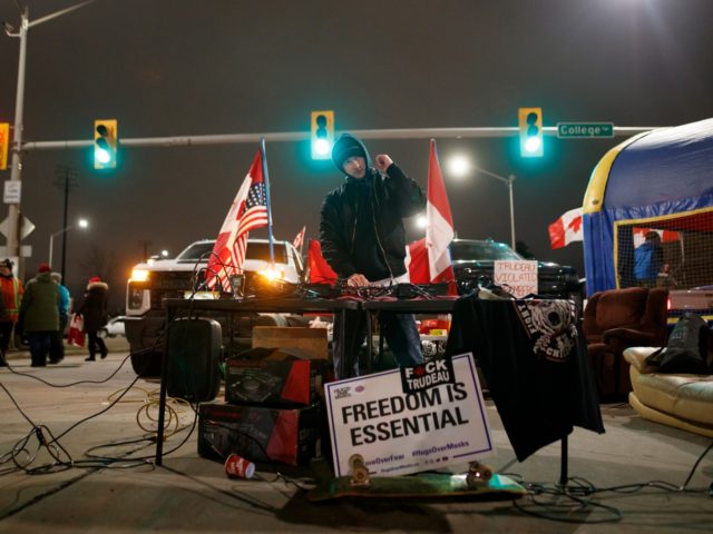 WINDSOR, ON - FEBRUARY 10: A DJ plays as protestors and supporters attend a blockade at the foot of the Ambassador Bridge, sealing off the flow of commercial traffic over the bridge into Canada from Detroit, on February 10, 2022 in Windsor, Canada. As a convoy of truckers and supporters …