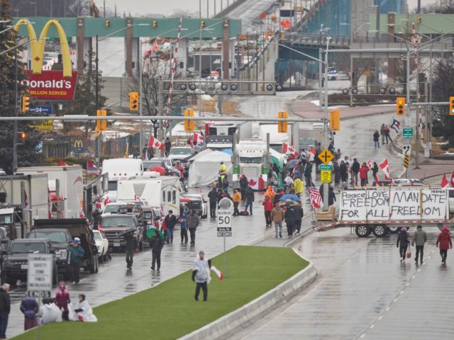 nti-vaccine mandate protestors block the roadway at the Ambassador Bridge border crossing, in Windsor, Ontario on February 11, 2022. - The protestors who are in support of the Truckers Freedom Convoy in Ottawa have blocked traffic in the Canada bound lanes from the bridge since February 7, 2022. Approximately $323 …