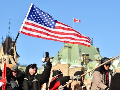 OTTAWA, ON - FEBRUARY 05: A supporter hold up a United States of America flag near Parliam