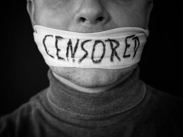 Bandaged mouth of a man with the word censored in English - stock photo freedom of speech