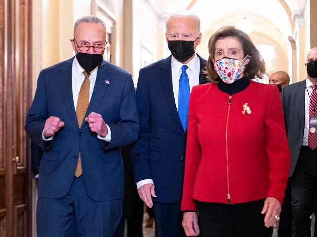 US President Joe Biden (C). with Speaker of the House Nancy Pelosi (R) and Senate Majority Leader Chuck Schumer, arrives at the US Capitol on January 6, 2022, to mark the anniversary of the attack on the Capitol in Washington, DC. - Thousands of supporters of then-president Donald Trump stormed …