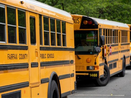 Fairfax County Public School buses set idle at a middle school in Falls Church, Va., Monda