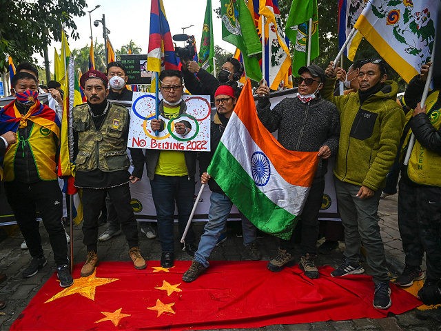 Tibetan Youth Congress (TYC) activists stomp on a Chinese national flag as they participat