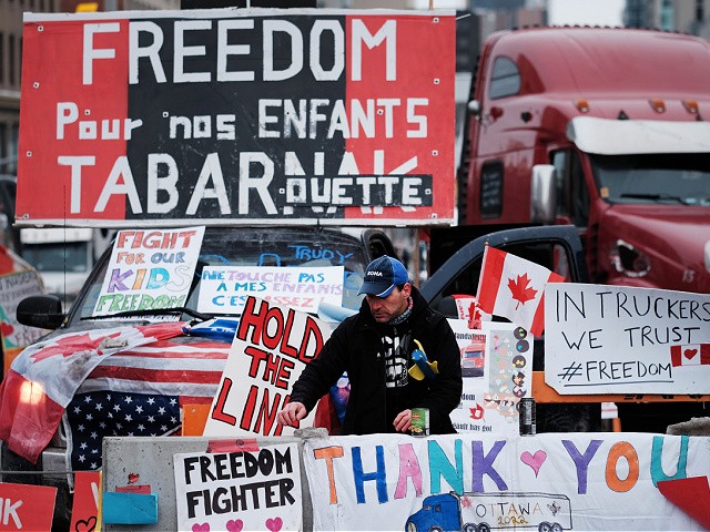 OTTAWA, ONTARIO - FEBRUARY 09: Truck drivers and their supporters gather to block the streets as part of a convoy of truck protesters against COVID-19 mandates on February 09, 2022 in Ottawa, Ontario. The protesters, whose goals and demands have shifted as more conservative and right-wing groups become involved, are entering their 13th day of blockading the area around the Parliament building. Over 400 vehicles have now joined the convoy which has forced businesses to close and unnerved residents. A state of emergency has been called in Ottawa as police and local officials decide on how best to bring the event to an end. (Photo by Spencer Platt/Getty Images)