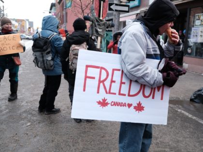 OTTAWA, ONTARIO - FEBRUARY 12: People gather and block the streets to take part in an anti