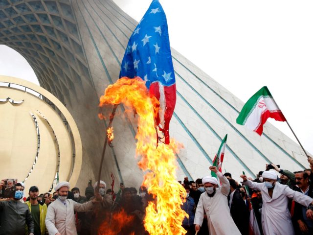Iranian clerics burn US flags during a rally marking the 43rd anniversary of the 1979 Isla