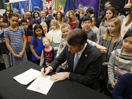 Virginia Gov. Glenn Youngkin signs an executive order establishing K through 12 lab schools while surrounded by children and educators at the Capitol, Jan. 27, 2022, in Richmond, Va. On Monday, Feb. 7, 2022, the Supreme Court of Virginia rejected a petition from parents that sought to invalidate Youngkin's executive …