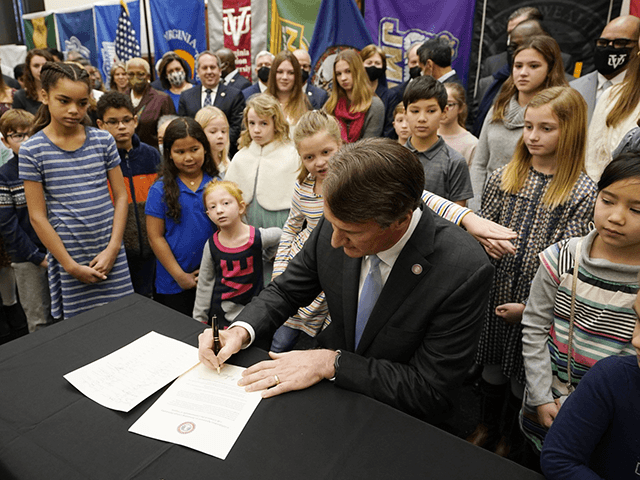 Virginia Gov. Glenn Youngkin signs an executive order establishing K through 12 lab schools while surrounded by children and educators at the Capitol, Jan. 27, 2022, in Richmond, Va. On Monday, Feb. 7, 2022, the Supreme Court of Virginia rejected a petition from parents that sought to invalidate Youngkin's executive order prohibiting school systems from enforcing mask mandates in the classroom. (AP Photo/Steve Helber, File)