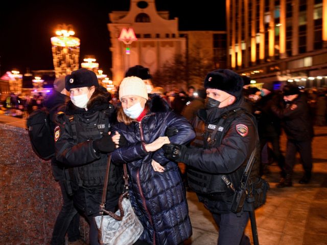 Police officers detain a demonstrator during a protest against Russia's invasion of Ukrain