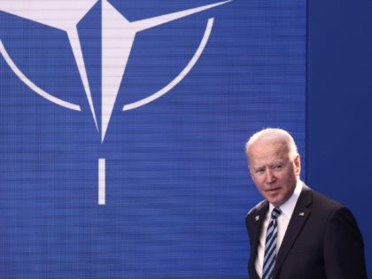 US President Joe Biden arrives to be greeted and pose for a photograph with the NATO Secre