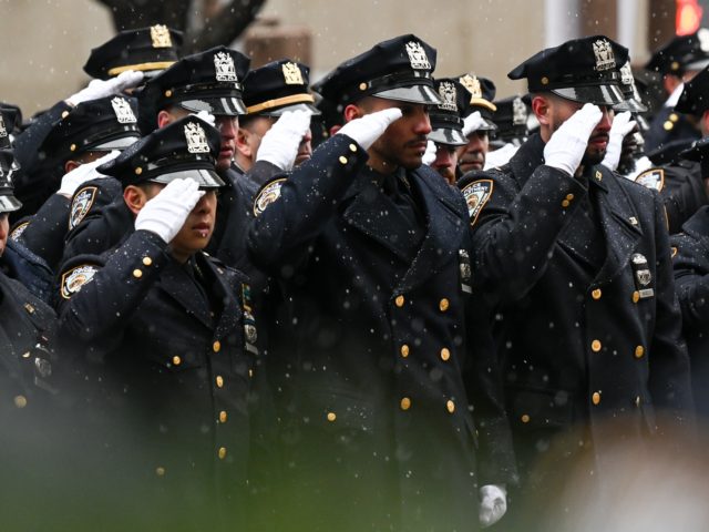NEW YORK, NEW YORK - JANUARY 28: Police officers salute as the procession of Officer Jason Rivera leaves St. Patrick’s Cathedral on January 28, 2022 in New York City. Twenty-two-year-old Officer Jason Rivera was shot and killed while responding to a domestic violence call last week and his partner, Officer …