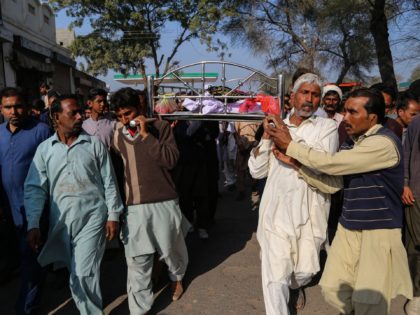 Relatives and locals carry a coffin containing the body of a man for his funeral at Khanew