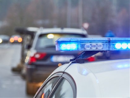 Blue lights of a police car at the scene of an accident - stock photo