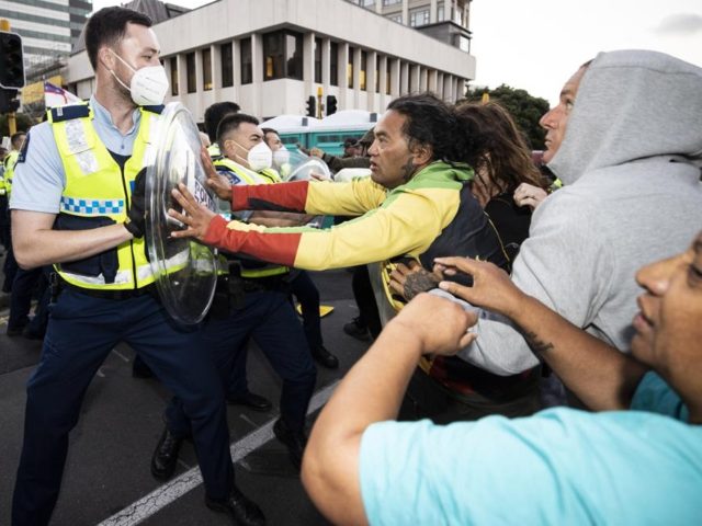 Police and protesters clash in Wellington, New Zealand, Tuesday, Feb. 22, 2022, as police tightened a cordon around a protest convoy that has been camped outside Parliament for two weeks. The protesters, who oppose coronavirus vaccine mandates and were inspired by similar protests in Canada, appear fairly well organized after …
