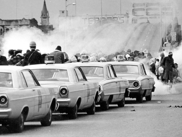 Clouds of tear gas fill the air as state troopers, ordered by Gov. George Wallace, break up a demonstration march in Selma, Ala., March 7, 1965, on what became known as "Bloody Sunday." The incident is widely credited for galvanizing the nation's leaders and ultimately yielded passage of the Voting Rights Act of 1965. (AP Photo/File)