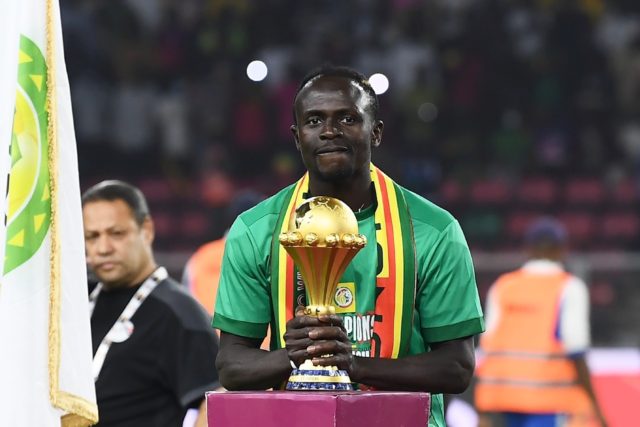 Sadio Mane with his hands on the trophy after he scored the decisive penalty in Senegal's